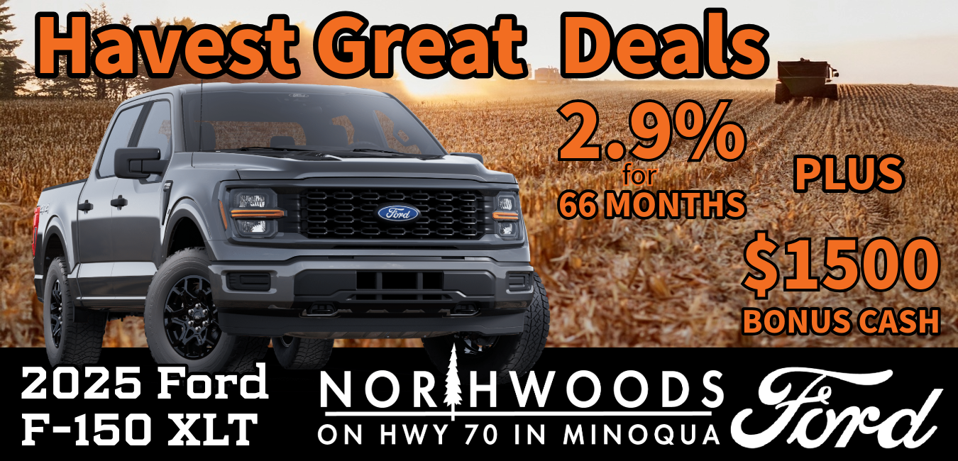 2025 Ford F-150 XLT driving along a dirt farm road in Northern Wisconsin surrounded by colorful fall foliage and hay bales