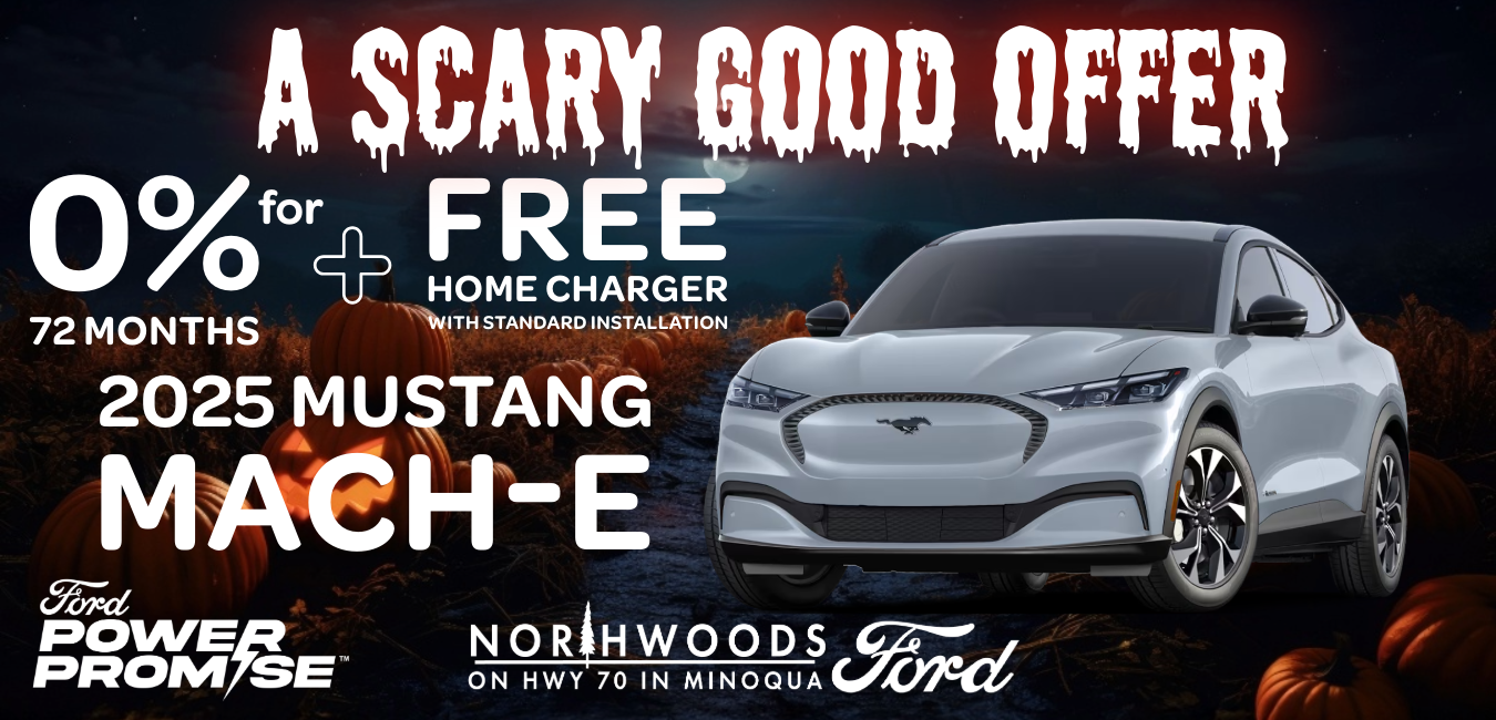 2025 Ford Mustang Mach-E driving through the Northwoods of Wisconsin on a fall evening with pine trees and a glowing moon.